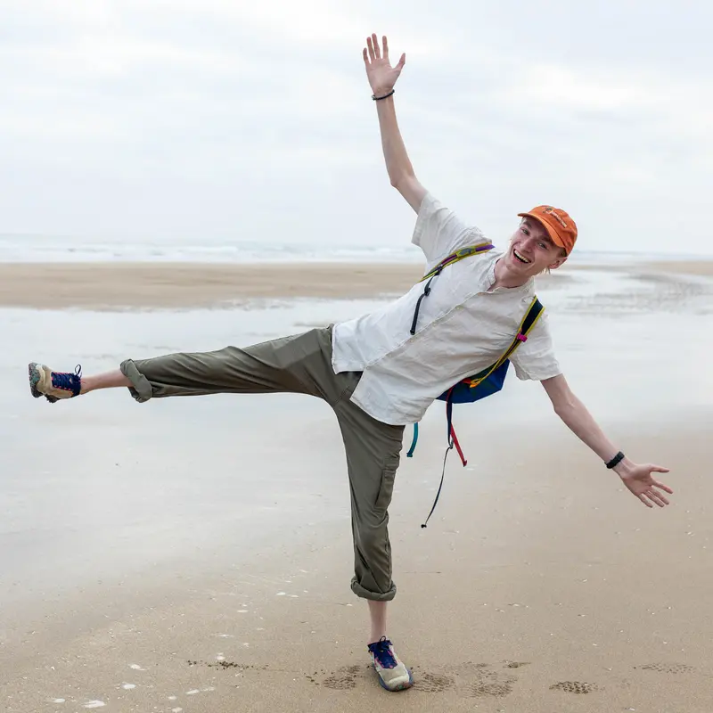 A portrait of the site creator, standing on one leg on the beach.